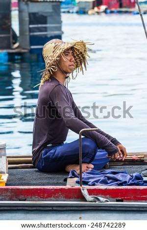 NHA TRANG, VIETNAM - SEP 30, 2014: Unidentified Vietmanese man on a boat on the Indochina sea. 90% of the Vietnamese people belong to the Viet ethnic group