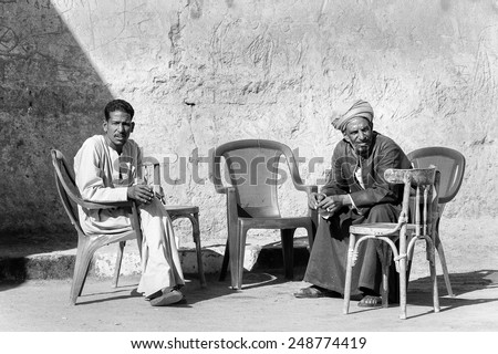ASWAN, EGYPT - DEC 2, 2014: Unidentified Egyptian men sit on the chairs. 90% of Egyptian people are Muslim