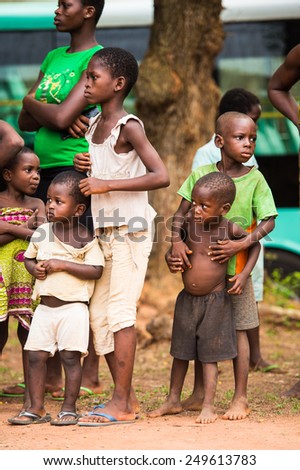 KARA, TOGO - MAR 9, 2013: Unidentified Togolese children watch and dance at the local music show. Children in Togo suffer of poverty due to the unstable econimic situation
