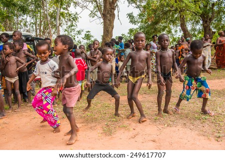 KARA, TOGO - MAR 9, 2013: Unidentified Togolese girl in pink pants dances during the local music show. Children in Togo suffer of poverty due to the unstable econimic situation