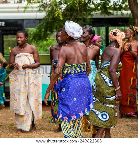 KARA, TOGO - MAR 9, 2013: Unidentified Togolese woman in a traditional African dress dances at the local music performance. People in Togo suffer of poverty due to the unstable econimic situation
