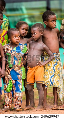KARA, TOGO - MAR 9, 2013: Unidentified Togolese children watch the local music show. Children in Togo suffer of poverty due to the unstable econimic situation