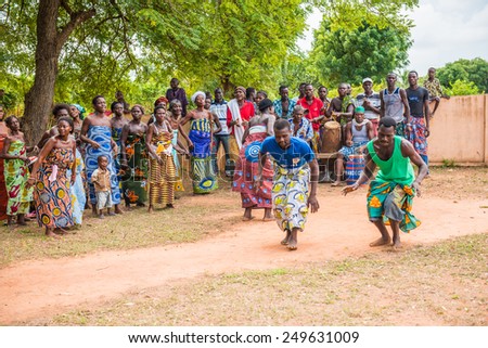 KARA, TOGO - MAR 9, 2013: Unidentified Togolese people watch and dance at the local music show. People in Togo suffer of poverty due to the unstable econimic situation