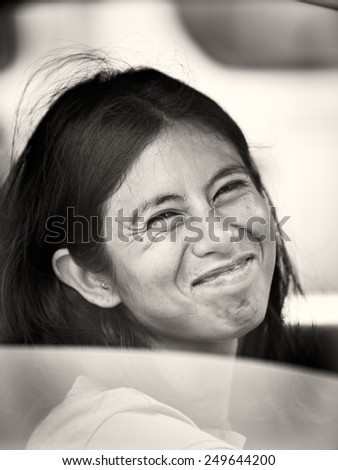SAN JOSE, COSTA RICA - JAN 6, 2012: Unidentified Costa Rican woman smiles out the car. 65.8% of Costa Rican people belong to the White (Castizo) ethnic group