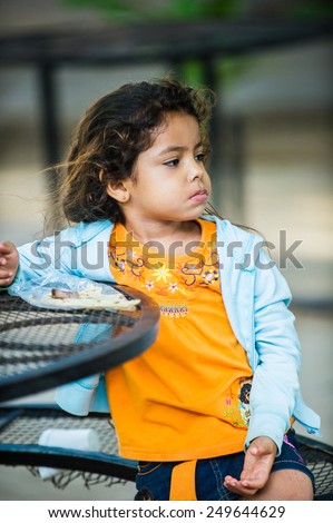 SAN JOSE, COSTA RICA - JAN 6, 2012: Unidentified Costa Rican girl sits at the table. 65.8% of Costa Rican people belong to the White (Castizo) ethnic group