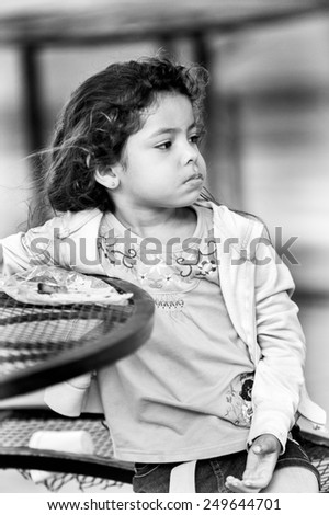 SAN JOSE, COSTA RICA - JAN 6, 2012: Unidentified Costa Rican girl sits at the table. 65.8% of Costa Rican people belong to the White (Castizo) ethnic group