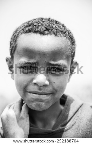 OMO VALLEY, ETHIOPIA - SEP 19, 2011: Unidentified Ethiopian boy feels joy of the life, in Ethiopia, Sep.19, 2011. People in Ethiopia suffer of poverty due to the unstable situation