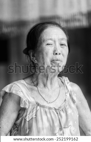 LUANG PRABANG, LAOS - SEP 25, 2014: Unidentified Lao woman in a yellow dress. 55% of Laos people belong to the Lao ethnic group