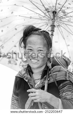 LAO CHAI VILLAGE, VIETNAM - SEP 22, 2014: Unidentified Hmong woman carries her little baby on her back in a village Lao Chai. Hmong is on of the minority eethnic group in Vietnam