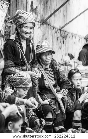 SAPA, VIETNAM - SEP 20, 2014: Unidentified Hmong people in a traditional costume work on a market. Hmong people is a minority ethnic group living in Sapa