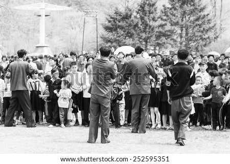 NORTH KOREA - MAY 1, 2012: Korean people are separating into 2 teams for tug of war game during the celebration of the International Worker\'s Day, May 1. May 1 is a national holiday in 80 countries