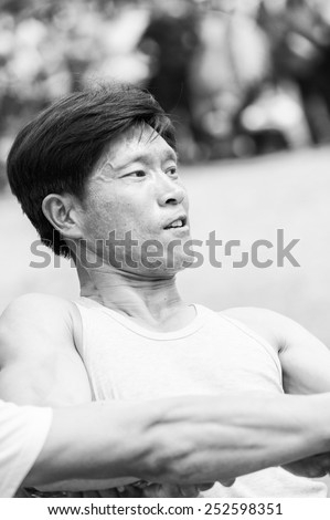 NORTH KOREA - MAY 1, 2012: Korean man actively participates in the tug of war game during the celebration of the Worker\'s Day in N.Korea, May 1, 2012. May 1 is a national holiday in 80 countries