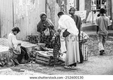 OMO, ETHIOPIA - SEPTEMBER 21, 2011: Unidentified Ethiopian people buy bananas at the market. People in Ethiopia suffer of poverty due to the unstable situation