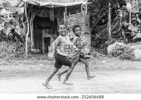 OMO, ETHIOPIA - SEPTEMBER 19, 2011: Unidentified Ethiopian boy runs screaming. People in Ethiopia suffer of poverty due to the unstable situation
