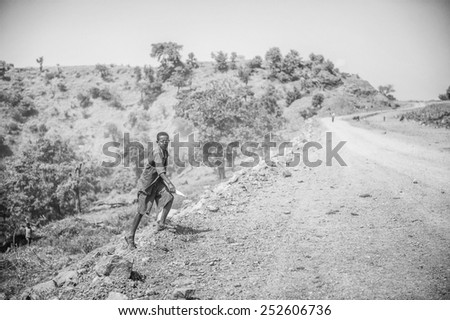 OMO, ETHIOPIA - SEPTEMBER 21, 2011: Unidentified Ethiopian boy runs on the road. People in Ethiopia suffer of poverty due to the unstable situation