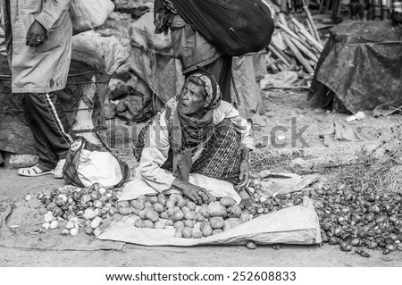OMO, ETHIOPIA - SEPTEMBER 21, 2011: Unidentified Ethiopian woman sells potatoes. People in Ethiopia suffer of poverty due to the unstable situation