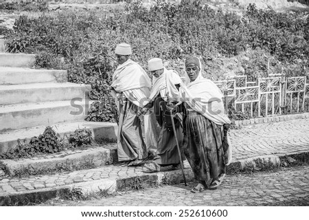 OMO, ETHIOPIA - SEPTEMBER 21, 2011: Unidentified Ethiopian men in white tissues. People in Ethiopia suffer of poverty due to the unstable situation