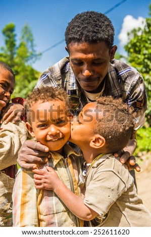 OMO, ETHIOPIA - SEPTEMBER 21, 2011: Unidentified Ethiopian girl kisses a boy. People in Ethiopia suffer of poverty due to the unstable situation