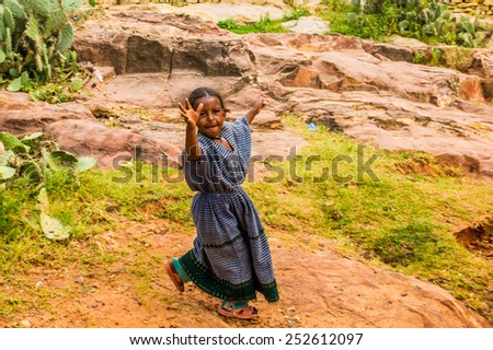 OMO, ETHIOPIA - SEPTEMBER 21, 2011: Unidentified Ethiopian girl runs in the street. People in Ethiopia suffer of poverty due to the unstable situation