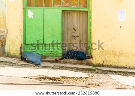 OMO, ETHIOPIA - SEPTEMBER 21, 2011: Unidentified Ethiopian woman sleeps at the door. People in Ethiopia suffer of poverty due to the unstable situation