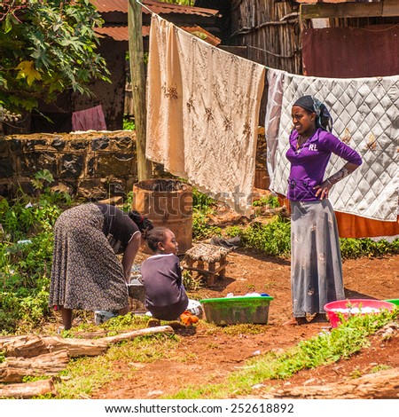 OMO, ETHIOPIA - SEPTEMBER 19, 2011: Unidentified Ethiopian woman hangs clothes. People in Ethiopia suffer of poverty due to the unstable situation
