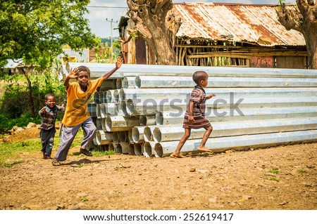OMO, ETHIOPIA - SEPTEMBER 21, 2011: Unidentified Ethiopian children run in the street. People in Ethiopia suffer of poverty due to the unstable situation