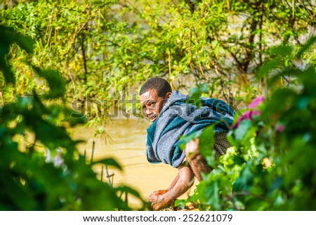 OMO, ETHIOPIA - SEPTEMBER 20, 2011: Unidentified Ethiopian man near the water. People in Ethiopia suffer of poverty due to the unstable situation