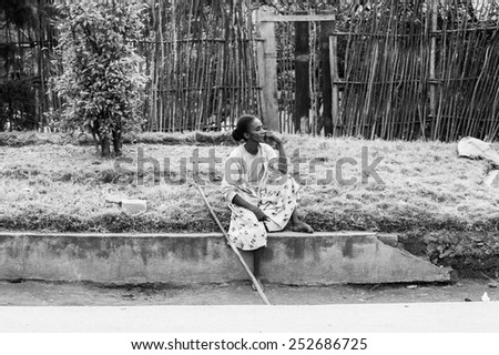ANTANANARIVO, MADAGASCAR - JUNE 30, 2011: Unidentified Madagascar girl sits and thinks. People in Madagascar suffer of poverty due to the slow development of the country