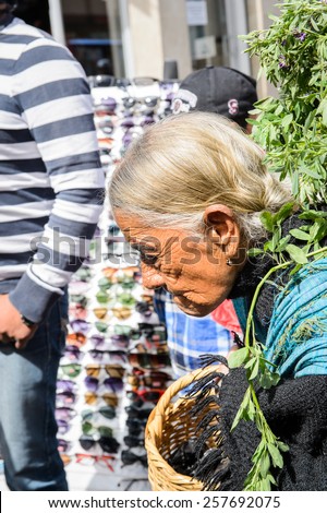 OTAVALO, ECUADOR - JAN 3, 2015: Unidentified Ecuadorian old woman carries a basket at the Otavalo Market. 71,9% of Ecuadorian people belong to the Mestizo ethnic group