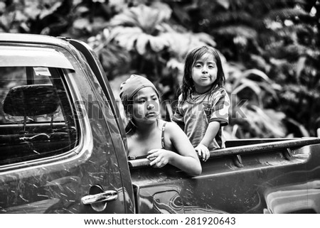 MINDO, ECUADOR - JAN 1, 2015: Unidentified Ecuadorian little girls in a back of the car. 71,9% of Ecuadorian people belong to the Mestizo ethnic group