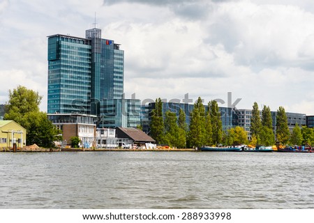 AMSTERDAM, NETHERLANDS - JUN 1, 2015: Architecture on the Canal of Amsterdam. Amsterdam is the capital city and most populous city of the Kingdom of the Netherlands
