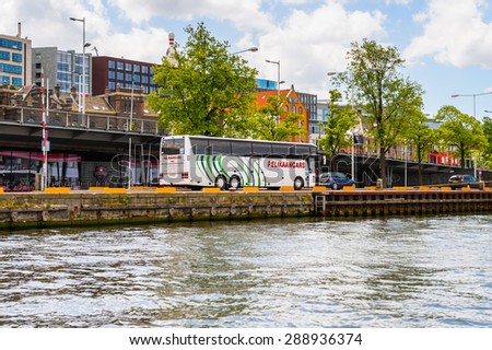 AMSTERDAM, NETHERLANDS - JUN 1, 2015: Floating boats on the Canal of Amsterdam. Amsterdam is the capital city and most populous city of the Kingdom of the Netherlands