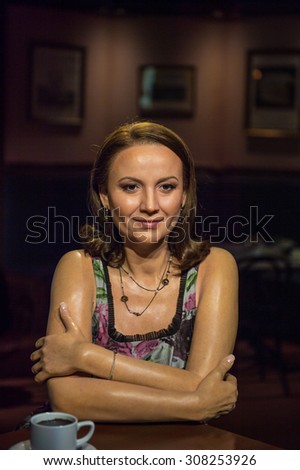 PRAGUE, CZECH REPUBLIC - JUNE 29, 2015: Wax woman drinks coffee in Grevin museum. Grevin is the museum of the wax figures in Prague