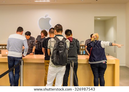 SAN FRANCISCO, USA - OCT 5, 2015: Unidentified clients in the Apple store in San Francisco. Apple Inc. is an American multinational technology company in Cupertino, California