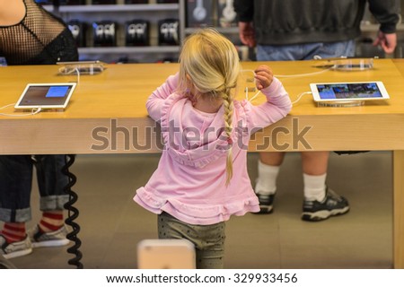 NEW YORK, USA - SEP 22, 2015: Unidentified people in the Apple store on the Fifth Avenue, New York. The store sells Macintosh personal computers, software, iPod, iPad, iPhone, Apple Watch, Apple TV
