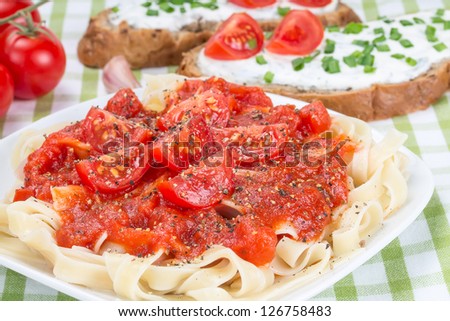 Egg noodles with ketchup, tomatoes, and sandwich