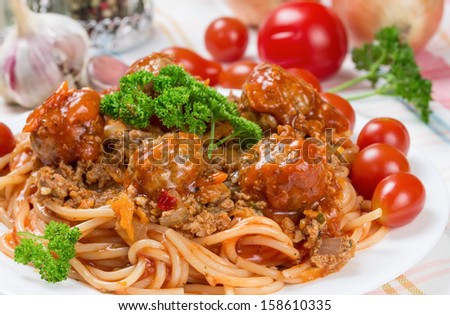 traditional Italian dish spaghetti bolognese with beef meatballs and parsley