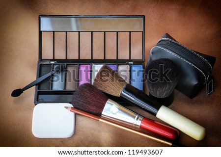 Make-up tools set including eye shadow, make-up brushes, eyebrow pencil, small bag and sponge.