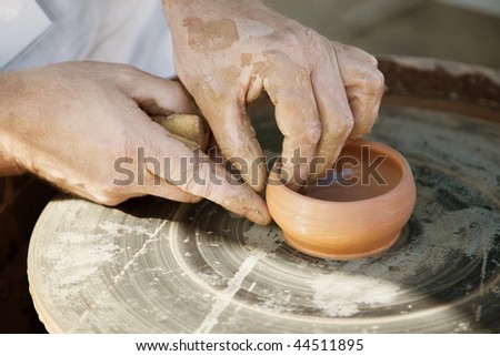 Potter\'s hands. Making dishes from clay.