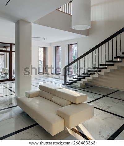 Luxury hall with big windows and staircase in modern style