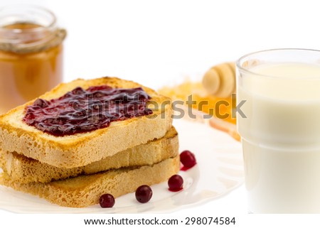 fresh french toast with honey and jam on a white plate with berries on a white background. healthy diet