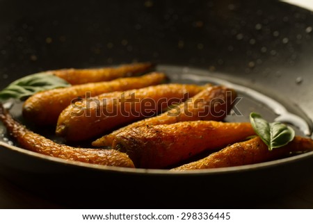 whole roasted carrots with spices in a skillet. Vegetarian healthy food