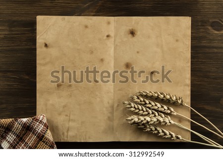 open old vintage book on the aged wooden background. wheat, cloth. Homemade, menu, recipe, mock up