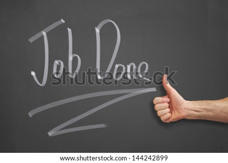Mans hand pointing to a Job Done message on a chalkboard.