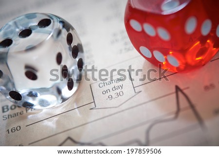 Stocks and shares Trading. Coloured dice on top of the financial section of a newspaper.