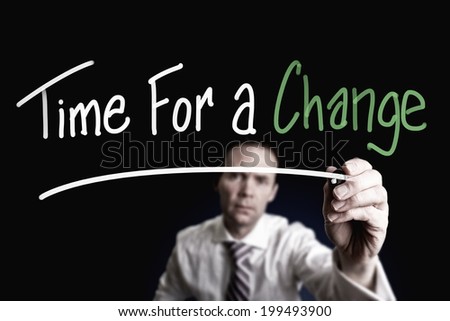 A businessman drawing a Time for Change concept on a glass screen.