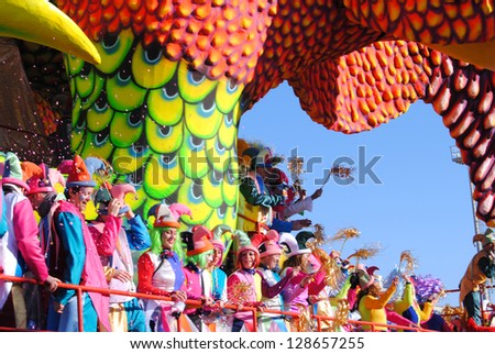 VIAREGGIO, ITALY - 10 FEBRUARY 2013. Festival.Colorful carnival float with happy, masked dancers during Carnival of Viareggio on february 10, 2013 in Viareggio, Italy