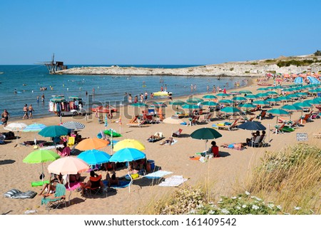 Apulia, ITALY, AUGUST 19: Beach with umbrellas and unidentified people at crowded beach near Vieste, Apulia,Italy,August 19, 2013. Vieste is marine resort in Gargano, received Blue Flags for its waters