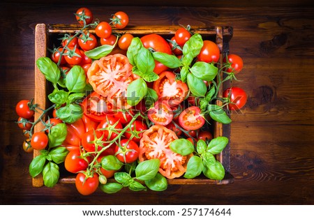 Tomatoes, basil on rustic wood background.Tomatoes sauce, pomarola.Organic vegetables, veg food background.