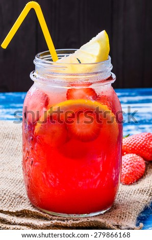 Strawberry lemonade, beverage.Fruit infused water with strawberries and lemon in mason jar.